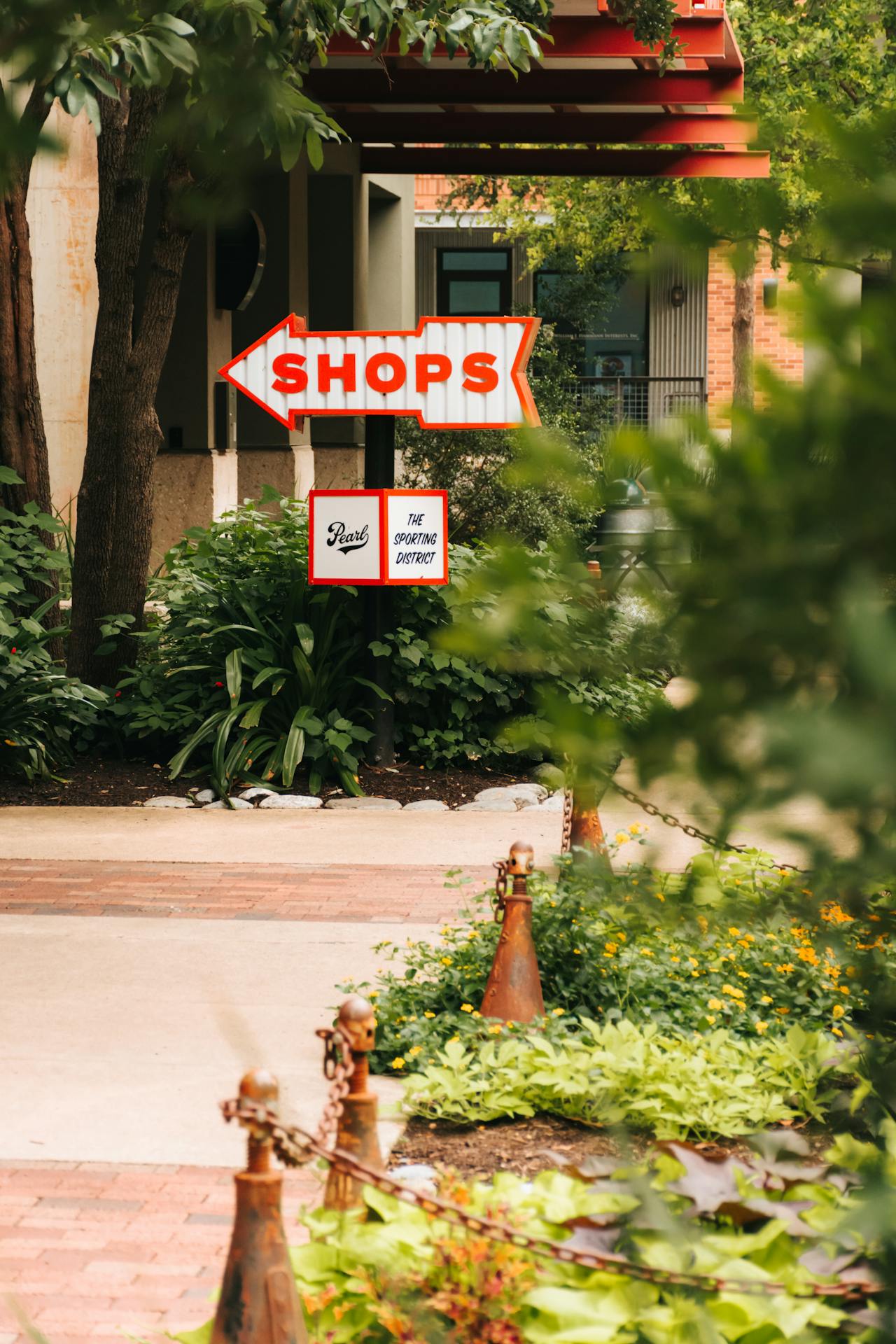 Vintage arrow sign pointing to a neighborhood shopping and dining district