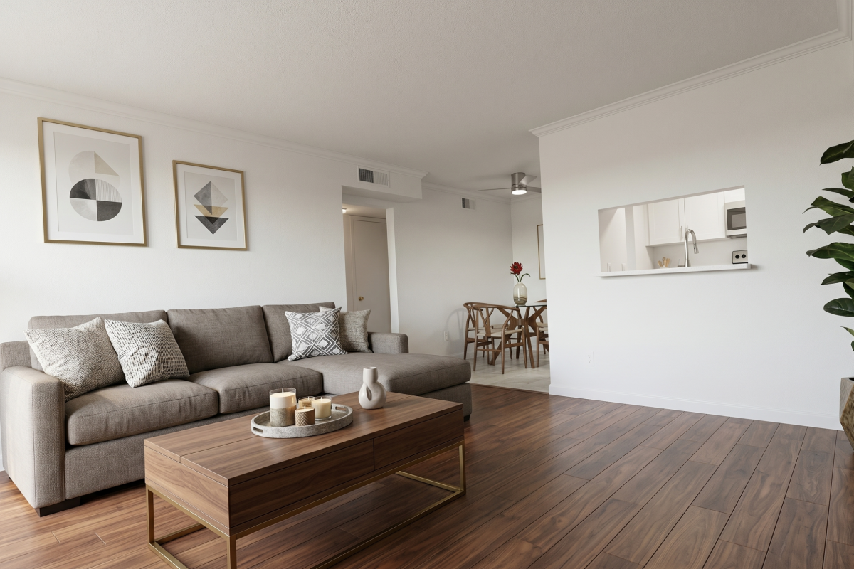 Open-concept living and dining area with a pass-through to the kitchen at Falls of Westpark apartment in Houston, TX