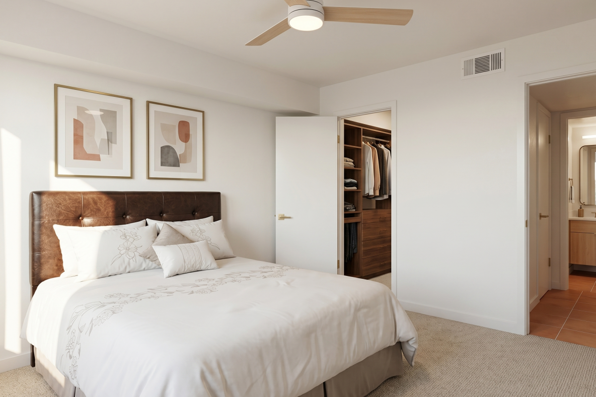 Bedroom with a walk-in closet and en-suite bathroom at Falls of Westpark apartment in Houston, TX